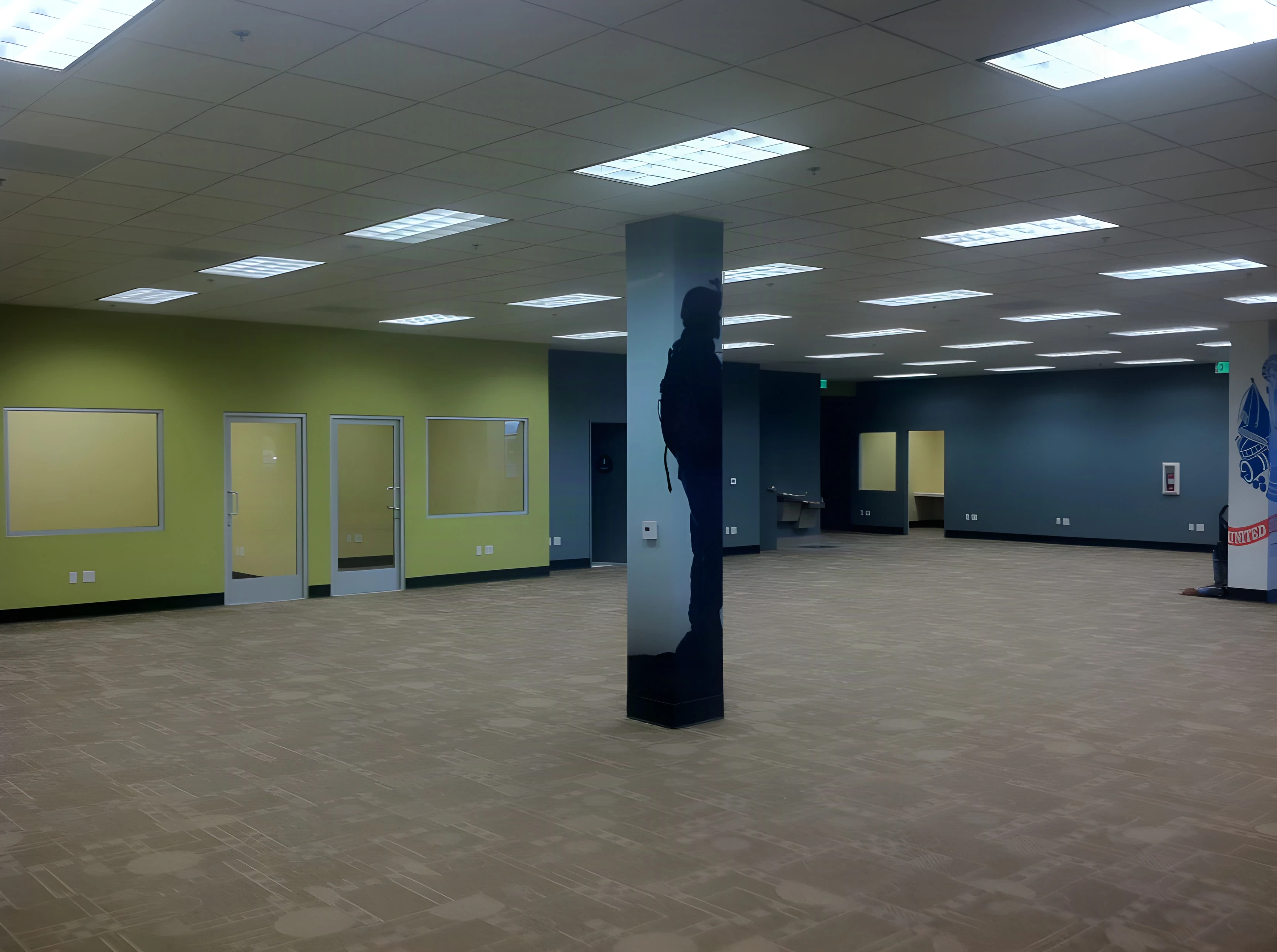 Open floor with green and blue walls and a soldier graphic column at the Army Career Center