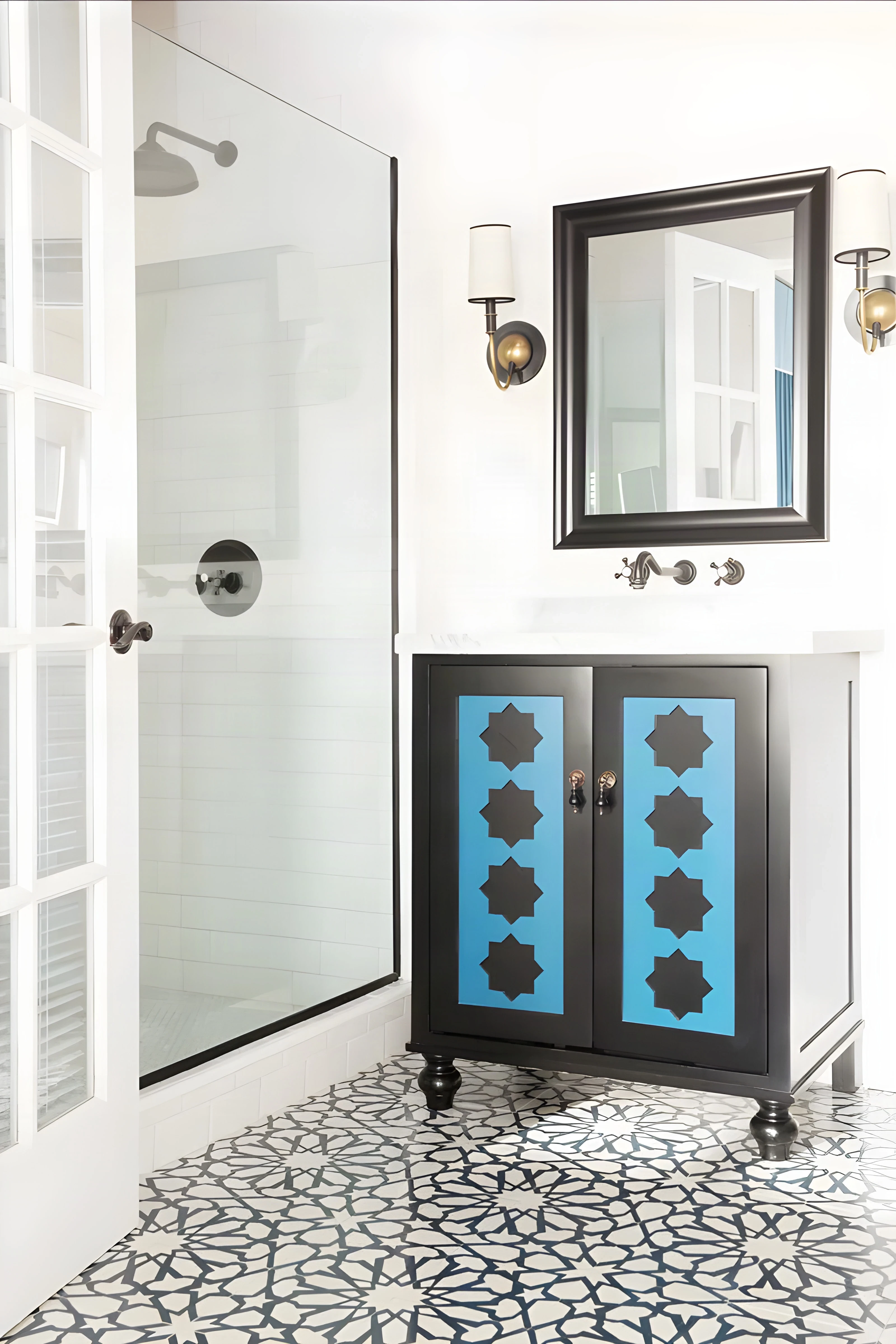 Blue star-cut vanity and black mirror in a white Casa Laguna bathroom