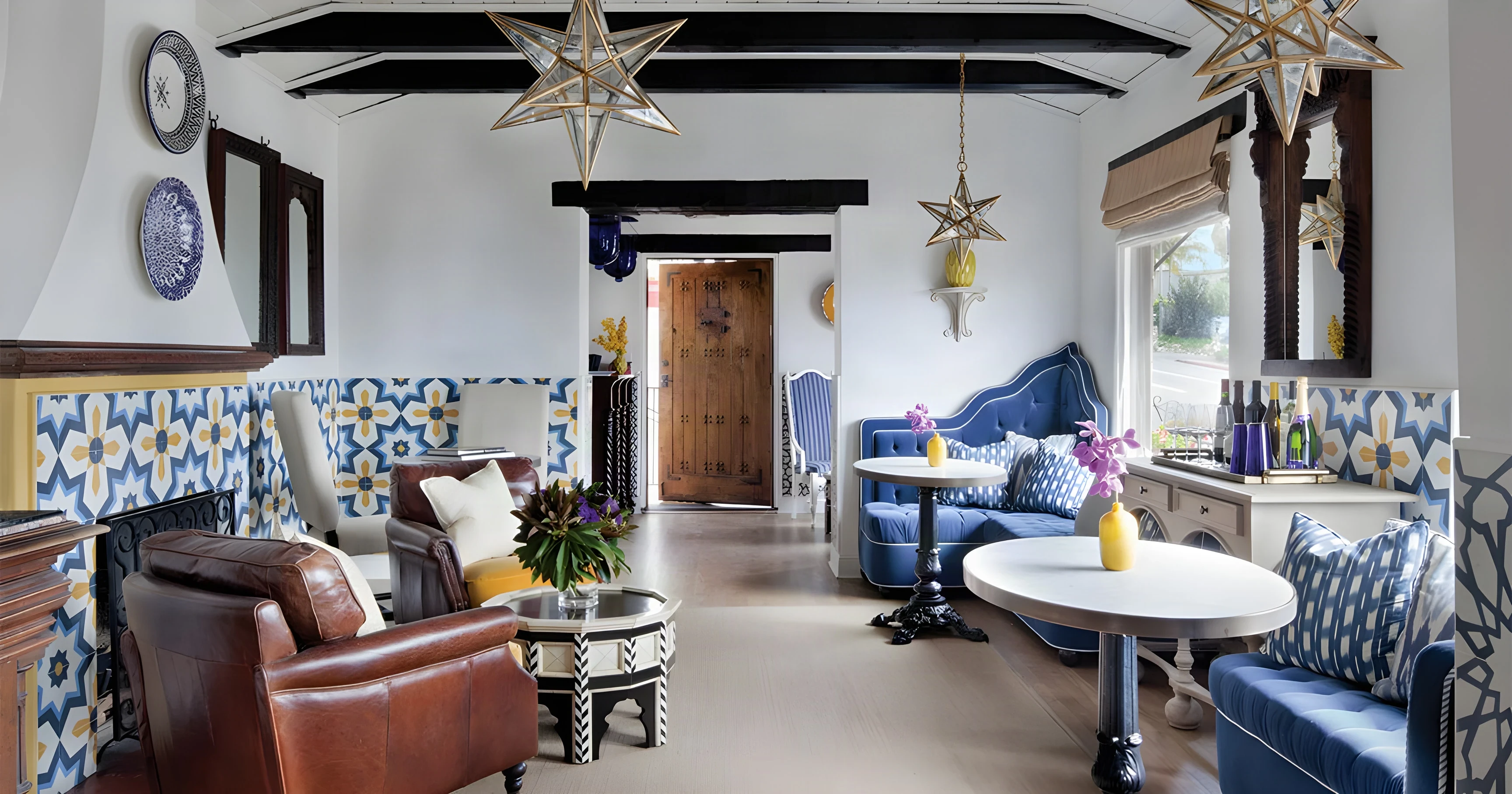 Casa Laguna lobby with star lanterns, blue tile wainscot, velvet banquettes and leather chairs