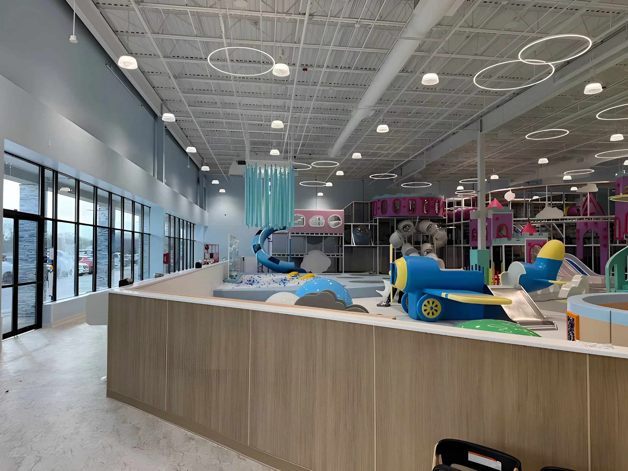 Wood reception counter overlooking the Cloudbound play structures in New Rochelle