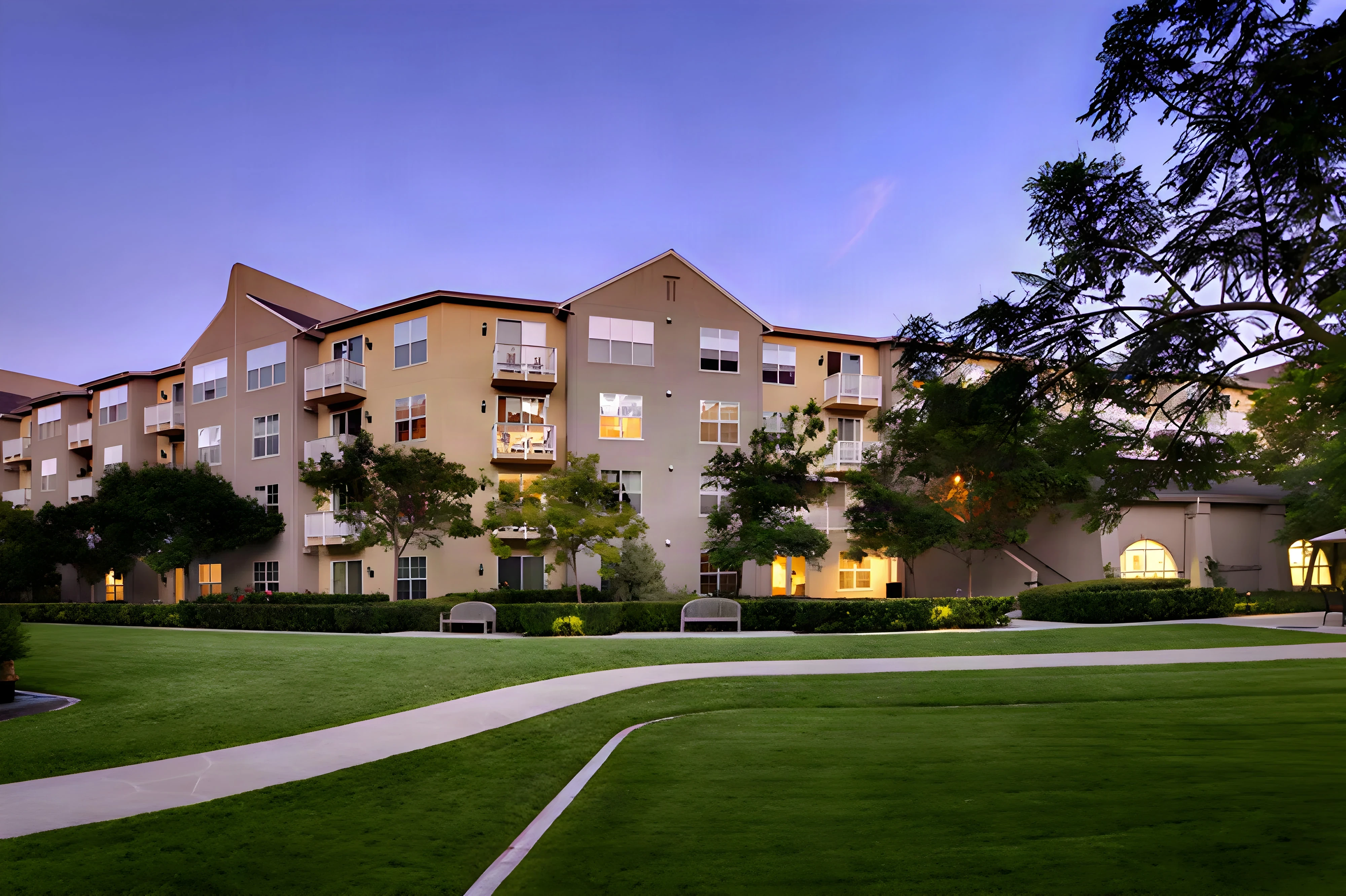 The Covington residences at dusk across a sweeping lawn in Aliso Viejo