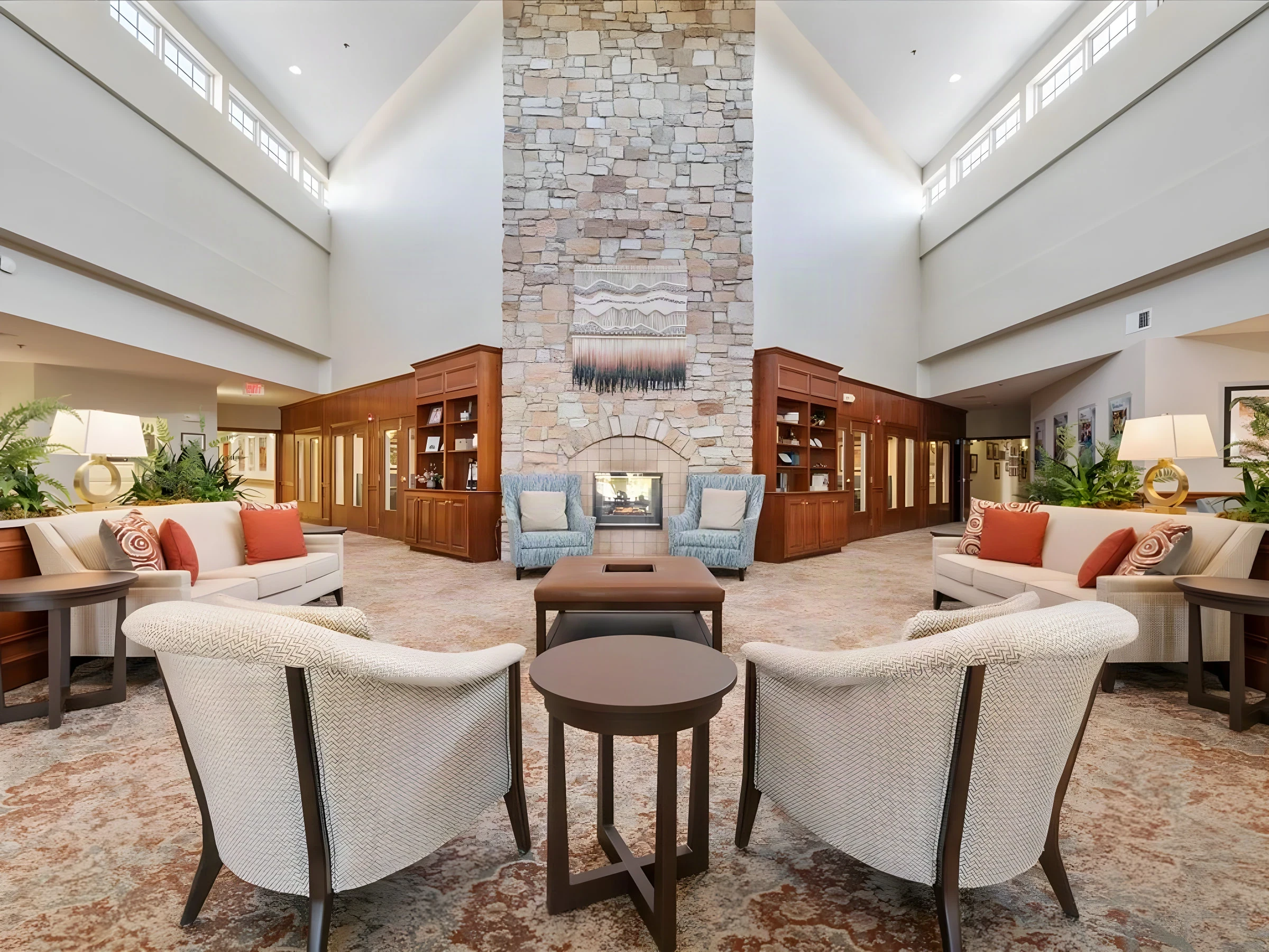 Double-height lobby at The Covington with a stone fireplace and upholstered seating