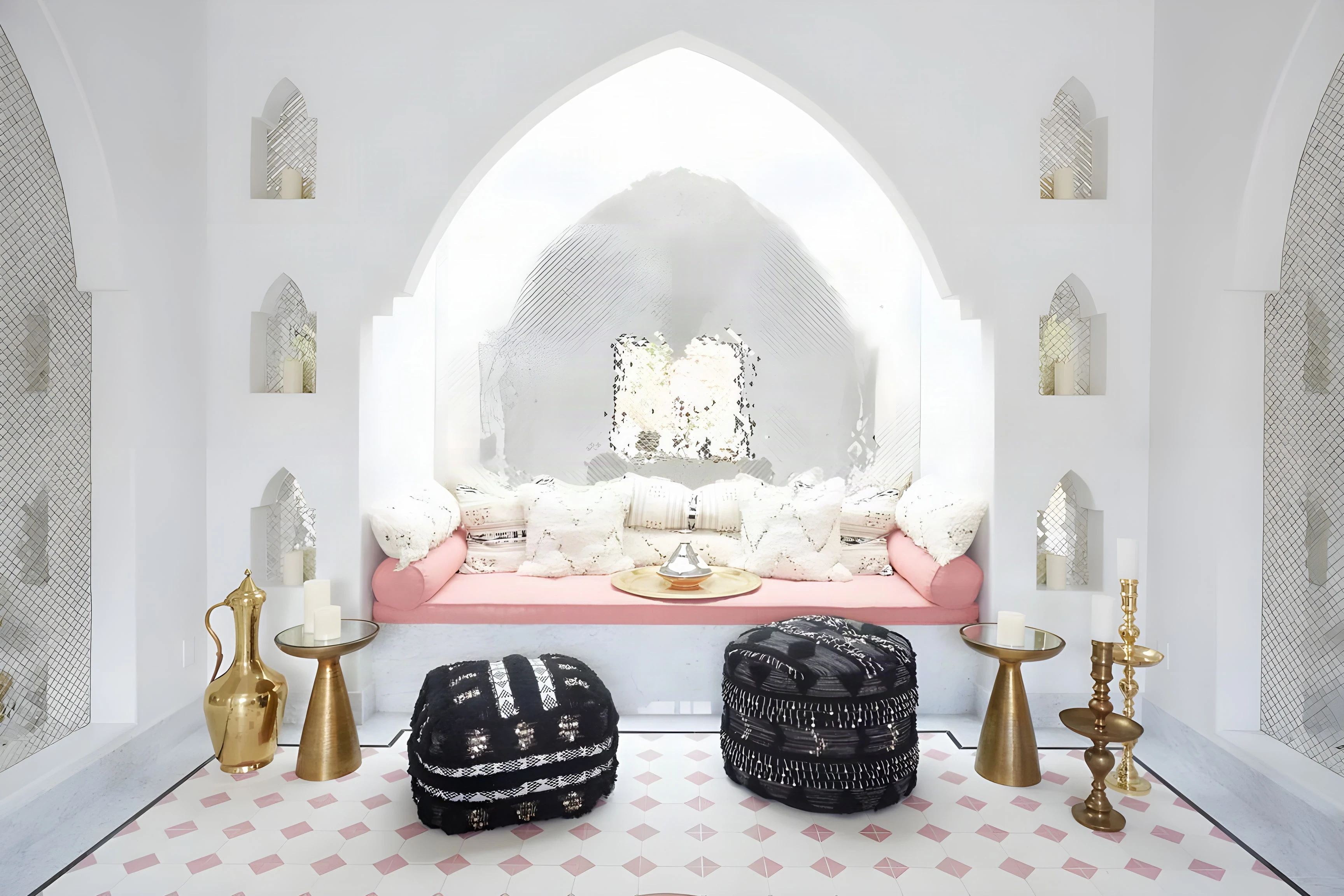 Arched white alcove with a pink daybed and mirrored mosaic at The Spa at Indian Wells